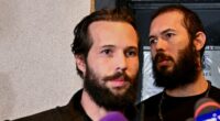 Andrew Tate, his brother and two alleged female accomplices have been released on house arrest from a Bucharest jail. Pictured: Andrew (right) and Tristan (left) leaving jail