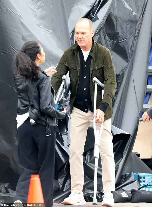 Michael Keaton, 71, supports himself with crutches as he films Goodrich in Los Angeles