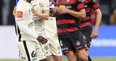 Nestory Irankunda of Adelaide United is held back from Calem Nieuwenhof of the Wanderers in the spiteful finish to the A-League match