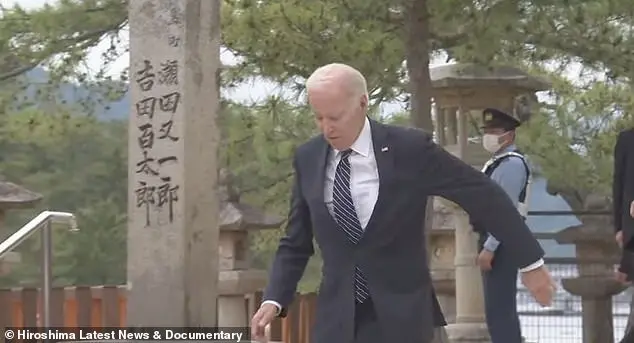 Biden stumbles while going to greet