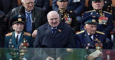 Belarusian President Alexander Lukashenko, centre, looks in pain as he watches the Victory Day military parade in Red square, Moscow, Russia, May 9, 2023