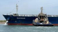 A tugboat works to refloat the Seavigour oil tanker to the waiting area in the Suez Canal, next to Ismailia, Egypt, on June 4, 2023