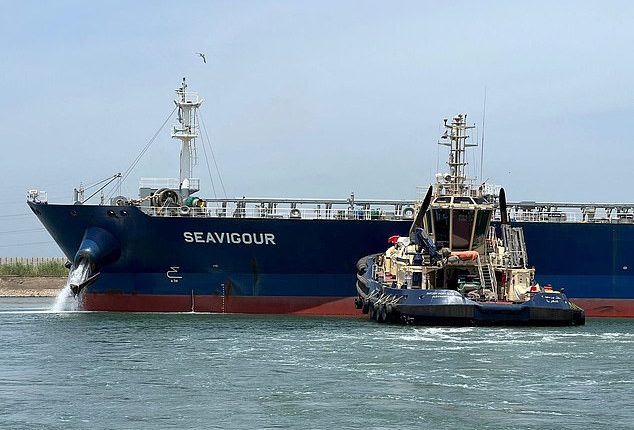 A tugboat works to refloat the Seavigour oil tanker to the waiting area in the Suez Canal, next to Ismailia, Egypt, on June 4, 2023