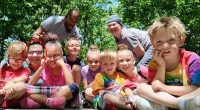 Natalia Grace (circled) is pictured beaming alongside her adoptive parents Cynthia and Antwon Mans and seven other children in a photograph on the family's new GoFundMe where they appeal for donations for a wheelchair-accessible van and funds for a dream trip to Israel