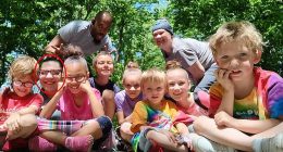 Natalia Grace (circled) is pictured beaming alongside her adoptive parents Cynthia and Antwon Mans and seven other children in a photograph on the family's new GoFundMe where they appeal for donations for a wheelchair-accessible van and funds for a dream trip to Israel