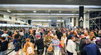 Passengers queue up at 4.20am today inside Manchester Airport's Terminal Two