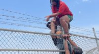 WATCH: Migrant families scale barbed wire fence into South Texas