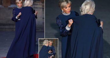 A fashion power duo! Brigitte Macron helps Queen Camilla adjust her cape ahead of State Banquet at the Palace of Versailles - as the pair dazzle in navy Dior gowns