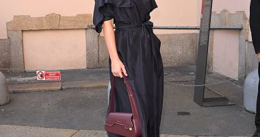 Glamorous: Bar Refaeli cut a stylish figure in a navy trench dress as she arrived at Milan Fashion Week on Thursday
