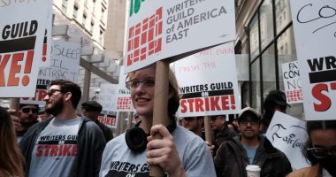 NEW YORK CITY - MAY 03: Members of the Writers Guild of America (WGA) East hold signs as they walk for the second day on the picket-line outside of Netflix's New York office on May 03, 2023 in New York City. WGA members were out on the first day of a Hollywood voters strike after the board of directors for the Writers Guild of America, which includes West Coast and East Coast branches, voted unanimously to call for a walkout. Negotiations between a top guild and a trade association that represents Hollywood’s top studios failed to avert the first walkout in more than 15 years. Union members have stated that they are not being paid fairly in the streaming era and are seeking pay increases and structural changes to the business model.  (Photo by Spencer Platt/Getty Images)