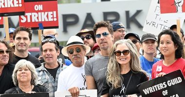 Battlestar Galactica cast members Sam Witwer, James Callis, Edward James Olmos, Michael Trucco and Mary McDonnell pose with writers and fans at the "Battlestar Galactica" themed picket during the SAG-AFTRA and WGA Strike held at NBCUniversal on September 21