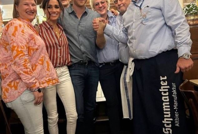 The Duchess of Sussex donned a structured red and white pinstriped shirt and her white frame jeans, plus Manolo Blahnik beige pumps, as she celebrated Prince Harry's birthday at dinner