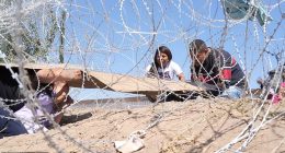 Shocking footage shows a mother and her young child crying out in horror as they crawl under a razor fence at the US southern border - only to be turned back the same way by Border Patrol agents. The video, taken in Juarez on the Mexico side of the border sees the group of Venezuelans placing cardboard on their backs to avoid being cut while crawling under the barb-wire obstacle placed to stop travelers from entering El Paso.