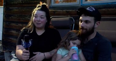 Thea, from the rural village of Faithorn in Michigan's Upper Peninsula, decided to go on an adventure on Wednesday when her mother Brooke had turned her back. Pictured: Thea with her father Alex and mother Brooke after she was found with her two dogs in wood