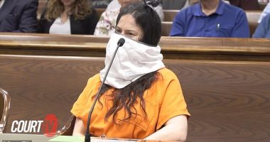 Taylor Schabusiness, 25, appeared to smile beneath the large white mask as she appeared in Brown County Circuit Court in a prison-issued orange jumpsuit with handcuffs around her wrists