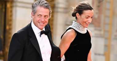 Royal navy! Camilla gets a kiss from Emmanuel Macron at Palace of Versailles while matching with Brigitte in blue ballgowns - as King Charles is greeted by President ahead of glittering State banquet attended by stars including Hugh Grant and Mick Jagger