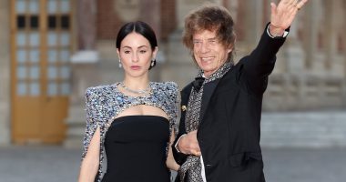 Sir Mick Jagger, 80, battles strong winds as he arrives at King Charles and Queen Camilla's Versailles state banquet alongside girlfriend Melanie Hamrick, 36