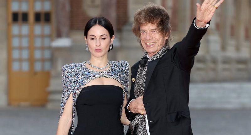 Sir Mick Jagger, 80, battles strong winds as he arrives at King Charles and Queen Camilla's Versailles state banquet alongside girlfriend Melanie Hamrick, 36