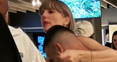 Taylor Swift wraps her arms around new lover Travis Kelce in first display of PDA after cheering on the NFL star with his mother at his game