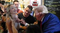 Trump Autographs Woman’s Shirt in Iowa Bar