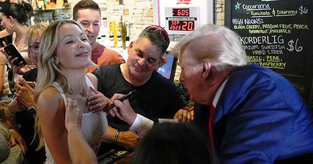 Trump Autographs Woman’s Shirt in Iowa Bar