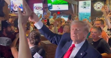 Donald Trump took time out of his campaigning schedule to hand out pizza to his supporters and even signed the top of one enthusiastic fan