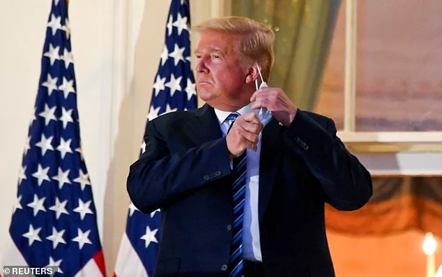 resident Donald Trump pulls off his protective face mask as he poses atop the Truman Balcony of the White House after returning from being hospitalized at Walter Reed Medical Center, October 5, 2020