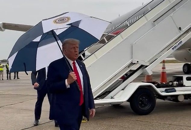 Donald Trump arrives in rainy Detroit