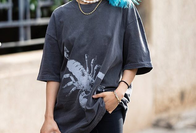 Vogue's youngest ever editor-in-chief Margaret Zhang, 30, rocked bright blue hair and yellow snakeskin boots as she attended Milan Fashion Week on Thursday