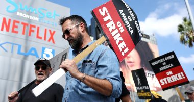 LOS ANGELES, CALIFORNIA - SEPTEMBER 18: Striking WGA (Writers Guild of America) members picket with striking SAG-AFTRA members outside Netflix studios on September 18, 2023 in Los Angeles, California. The Writers Guild of America and Alliance of Motion Picture and Television Producers (AMPTP) are set to meet for a new round of contract talks this week in the four-months long writers strike. (Photo by Mario Tama/Getty Images)