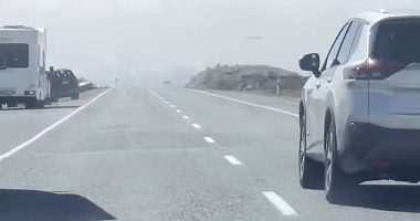 The fully-loaded vehicle was blown over on New Zealand 's Mount Cook Road, which leads deep into the southern alps and the country's tallest mountain, Aoraki, at 2pm on Sunday