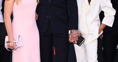 Fashionable family: Harper Beckham, 12, followed in her mother's fashionable footsteps in a stylish pink gown and £890 clutch bag as she joined her parents at the BECKHAM premiere