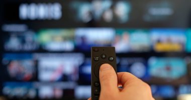 Remote control and screen - binge watching the favorite TV show