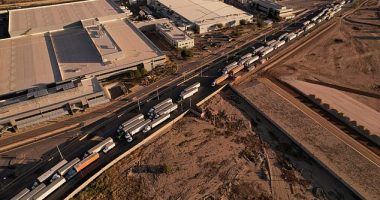 Trucks hauling freight containers wait on a road near the Zaragoza-Ysleta border crossing bridge on September 18. U.S. Customs and Border Protection has paused inspections for a week as agents have been transferred to Texas border cities to help with the processing og migrants, in some instances up to 2,000 a day