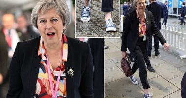Theresa May shuns her usual striking heels as she steps out in trendy Converse trainers at Tory conference