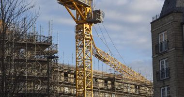 Horrified resident heard a 'big bang' and felt her entire building shake when huge crane collapsed onto new-build apartments in Edinburgh - injuring two people