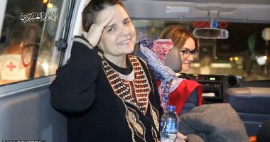 A young female hostage was seen enthusiastically saying 'goodbye' to a masked and armed Hamas gunman