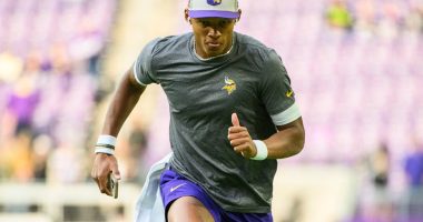 Joshua Dobbs, whose father is of Caucasian ancestry and his mother is of African-American ethnicity, warms up before a game