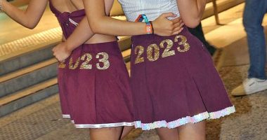 Pictured, young woman holding a vape while at schoolies celebrations