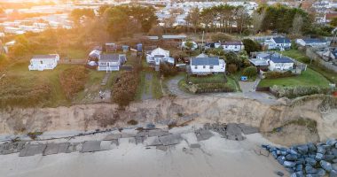 Emergency vehicles can't reach our homes - now we're being threatened with court action: Furious villagers on crumbling coast slam council for abandoning their homes - as they're left stranded after access road collapses following a land slip