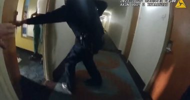 Shocking police bodycam footage captured the moment three officers entered a hotel room to find a suspected gunman inside around several children, where he was trying to 'escape'