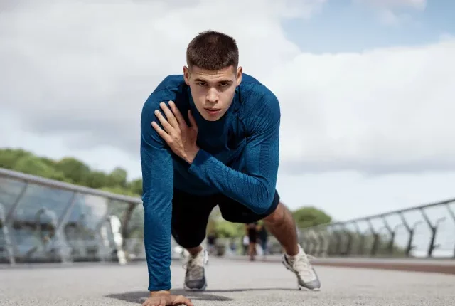 fit man demonstrating plank shoulder taps to reach your ideal weight fast