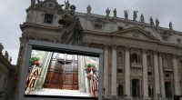 A file image of a giant monitor in St. Peter's Square at the Vatican, from 2013 that shows the heavy wooden door to the Sistine Chapel being closed and locked, signalling the start of the conclave to elect a new pope.