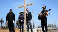 Members of burned LA church bear a cross through their devastated neighborhood to mark Good Friday