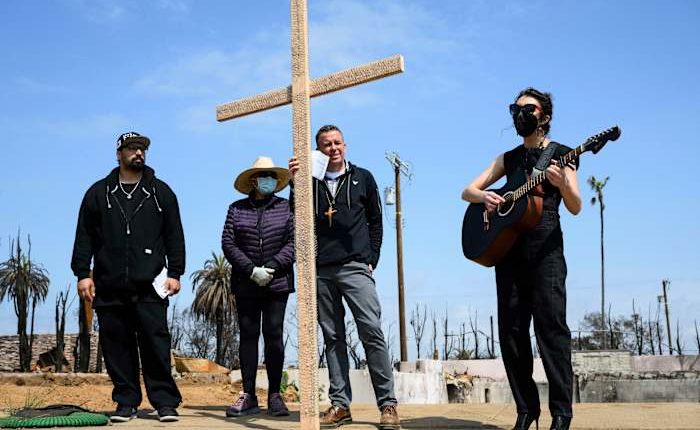 Members of burned LA church bear a cross through their devastated neighborhood to mark Good Friday
