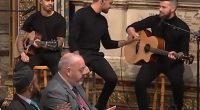 Liam Payne fist-bumps his bandmates after performing John Mayer's hit Waiting on the World to Change