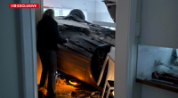 Car lands in woman's living room.