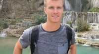 Man in front of a waterfall.