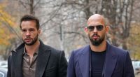 Two men in suits outdoors.