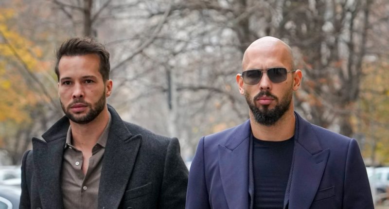 Two men in suits outdoors.